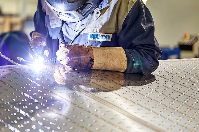 This image shows the welding process for Dimple Plate connections providing structural integrity.